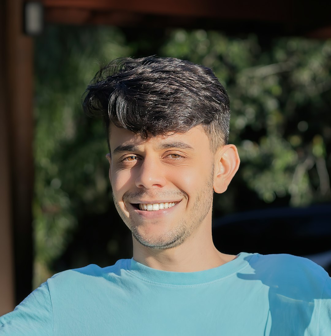 Confident young Turkish male journalism student smiling